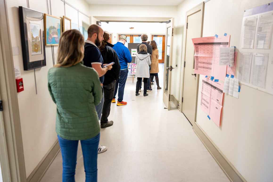 voters waiting in line at a polling station